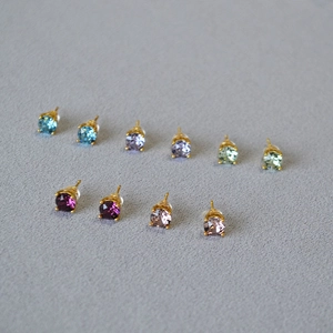 Close-up of multicolor crystal stud earrings set with 925 silver needles in gold plating
