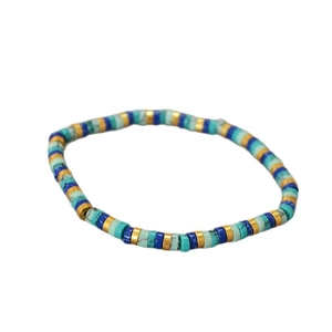 Bohemian style turquoise and gold beaded elastic bracelet with vintage minimalist aesthetic
