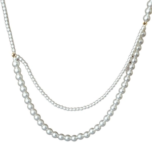 Double-layered white pearl necklace with gold connectors on minimalist white background