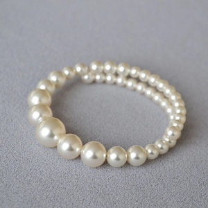 Close-up of elegant multi-layer faux pearl bracelet with gradient size beads