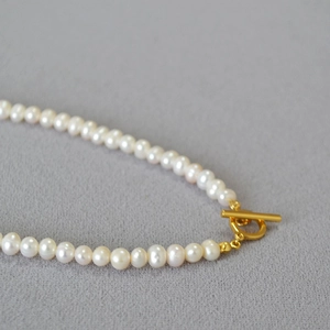 Macro shot of irregular baroque freshwater pearls and golden OT toggle clasp detail