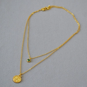Double-layer gold brass necklace featuring an Egyptian cat coin and green malachite bead