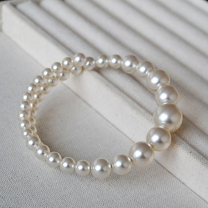 Macro shot of French style gradient faux pearls in a luxury jewelry display box
