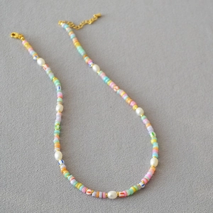 Macro shot of colorful beads and irregular freshwater pearls on bohemian style necklace