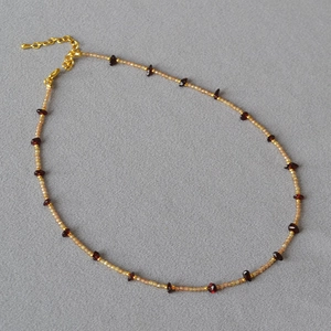Detail of irregular purple amethyst beads and gold clasp on a minimalist handmade necklace