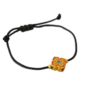Adjustable black woven bracelet with golden enamel square bead in traditional style