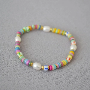 Macro detail of Bohemian beaded necklace with colorful sea shells and white pearls