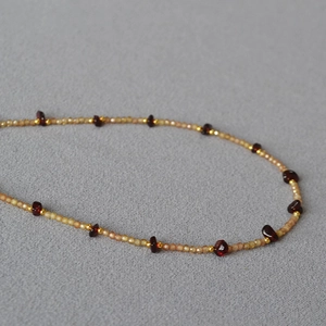 Macro shot of an elegant beaded necklace with gold accents and purple crystal details