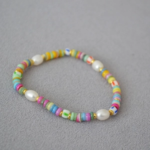 Macro shot of colorful clay beads and pearls on a bohemian beaded necklace