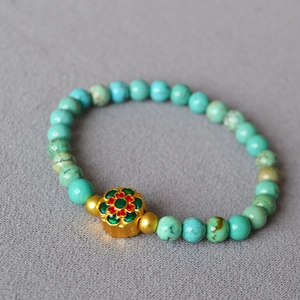 Vintage brass turquoise beaded bracelet featuring a red and green enamel flower pendant