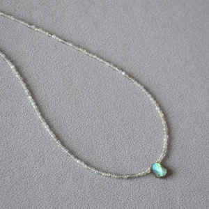 Labradorite beaded necklace with faceted grey stones and a blue teardrop pendant