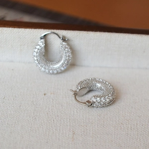 Silver thick hoop earrings with shimmering full zircon pave in minimalist luxury design