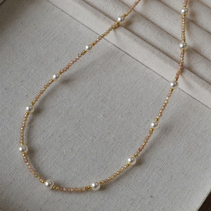 Close-up of elegant champagne faceted beads and white freshwater pearl necklace