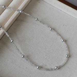 Detail of beaded necklace with grey pearls, faceted labradorite and silver spacers