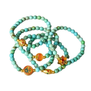 Vintage turquoise beaded bracelet with gold-colored enamel floral accents for women