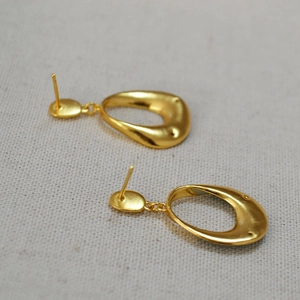 French vintage matte gold drop earrings with organic ring design on linen fabric