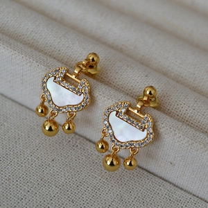 Detail of Ruyi lock earrings with white mother-of-pearl and sparkling zircon stones