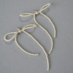Elegant handmade pearl bow earrings with long tassels and delicate woven beadwork
