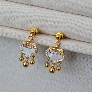 Detail of golden Ruyi lock earrings with white mother-of-pearl and sparkling zircon inlays