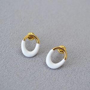 Irregular oval white enamel stud earrings in gold plated brass with minimalist design