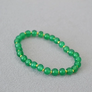Green agate bead bracelet with golden spacers, handcrafted elastic jewelry design