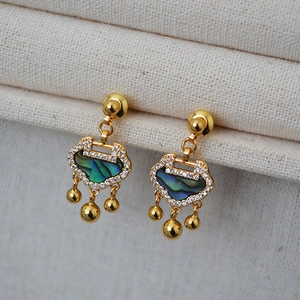 Detail of Ruyi lock earrings with mother-of-pearl shell and white zircon accents