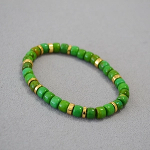 Detailed macro shot of vintage turquoise beads and gold spacers on a stretch bracelet