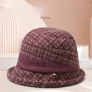 Detailed view of the dark red winter cloche hat with textured floral print and brim