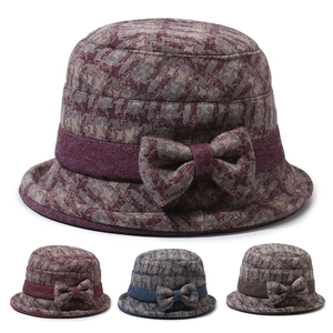 Detail view of winter cloche hat for elderly women with plaid pattern and bow decoration