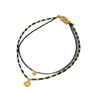 Double-layered black bead necklace with gold star and vintage coin sunburst charms