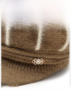 Detail view of winter knitted beanie with golden diamond ornament and soft fleece texture