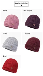 Detail view of five warm winter knit beanies with thick texture and metal X decor