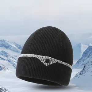 Close-up of black ribbed knit beanie with grey stripe and mountain snow background