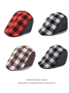 Close-up of checkered newsboy caps in four colors with faux leather brim detail