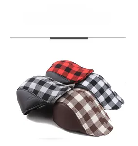 Detailed display of vintage plaid flat caps in red, grey, white, and brown with leather trim