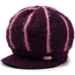 Detailed view of the purple knitted newsboy cap with gold buckle and fleece texture