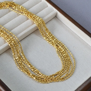 Close-up of gold layered popcorn bead chain necklace with adjustable lobster clasp