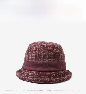 Front view detail of a burgundy floral print winter bucket hat for elderly women