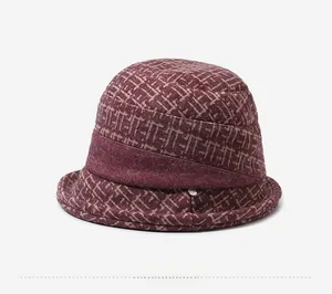 Detail view of winter bucket hat for elderly women in deep red geometric floral print