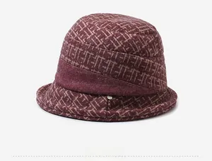 Detailed side view of wine red vintage cloche hat with textured geometric patterns