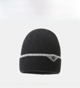 Detailed view of black ribbed knit beanie with grey stripe and warm fleece lining