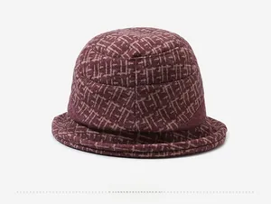Detail view of the back of a wine red winter bucket hat with beige geometric patterns