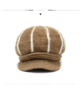 Front view of thick brown cable knit newsboy hat with white stripes and metal accessory