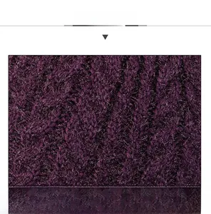 Close-up of dark purple knitted fabric texture showing soft warm fleece material details