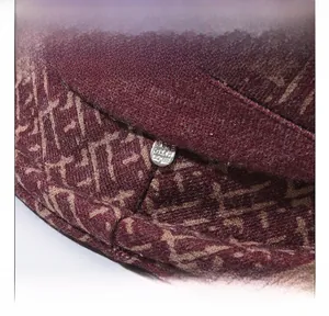 Macro detail of wine red wool blend winter hat featuring geometric jacquard pattern