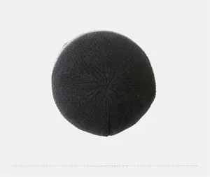 Top down view of black ribbed knit beanie showing textured knit pattern and stitch detail