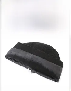 Close-up of black ribbed knit beanie featuring soft warm fleece lining and fabric label