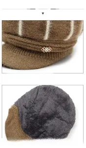 Detail of coffee knit beanie showing white stripes, metal accent, and plush fleece lining