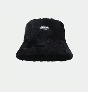 Detail of black faux fur bucket hat with IMMUNE logo patch and warm fuzzy texture