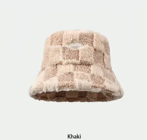 Detailed texture of khaki plaid faux fur bucket hat with an embossed immune logo label
